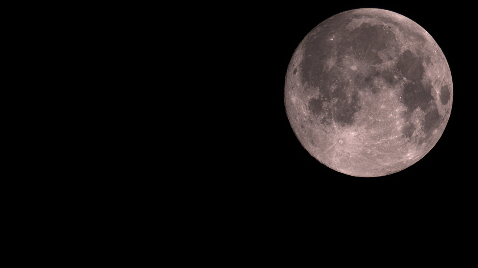 The nearly full Moon with craters and dark lunar maria